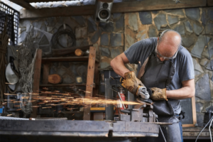 A person performing custom metal fabrication in a shop in El Paso.